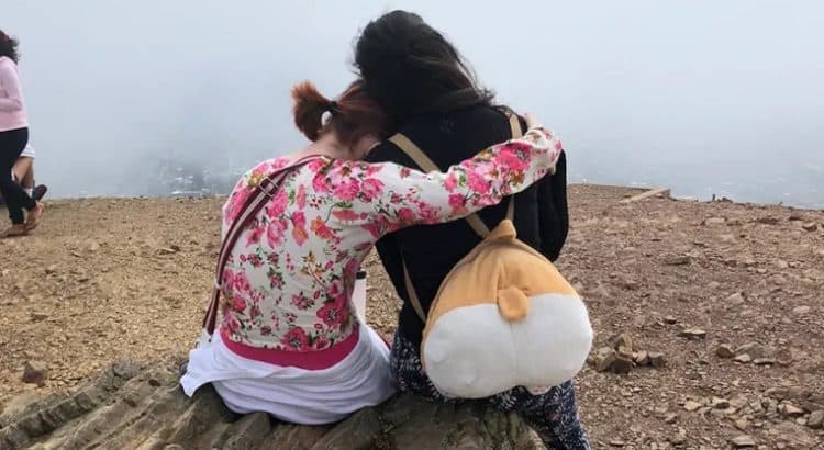 Zoe and Yesenia embrace after hiking